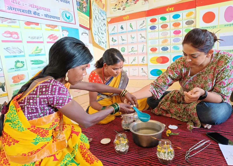 Women of Katkari tribe making candles with a trainer