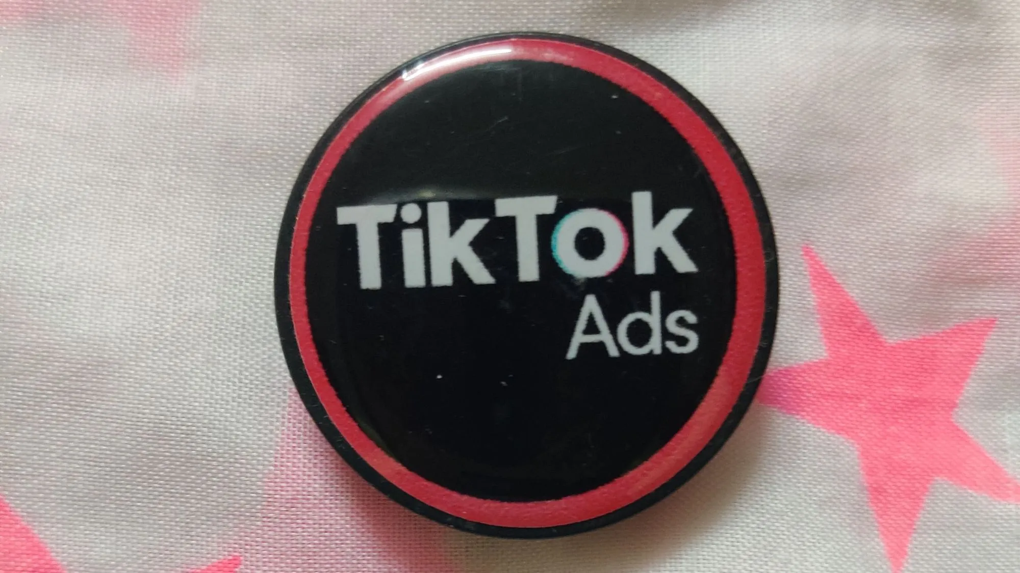 A phone pop socket with TikTok branding  