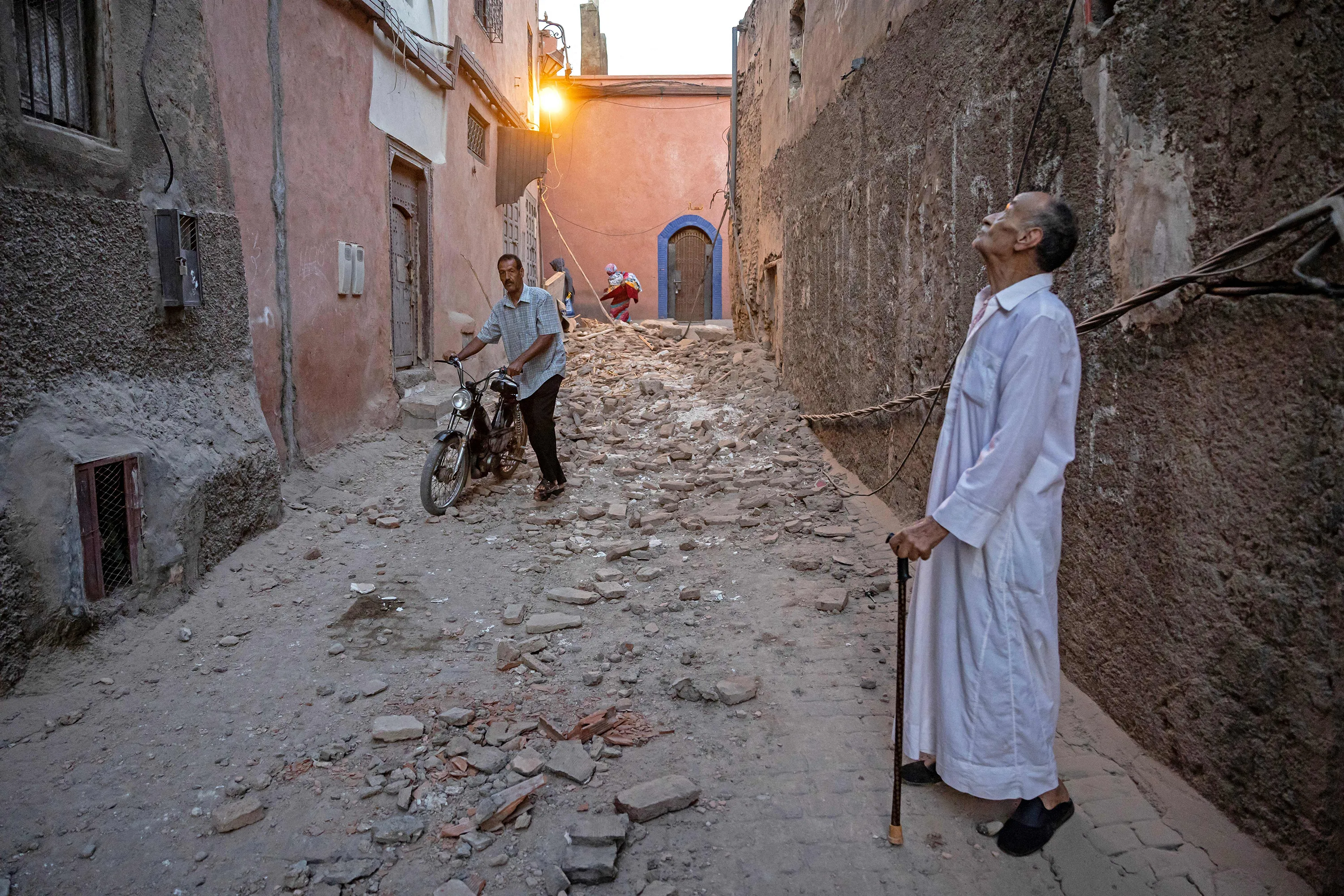 A resident looks at a damaged building.