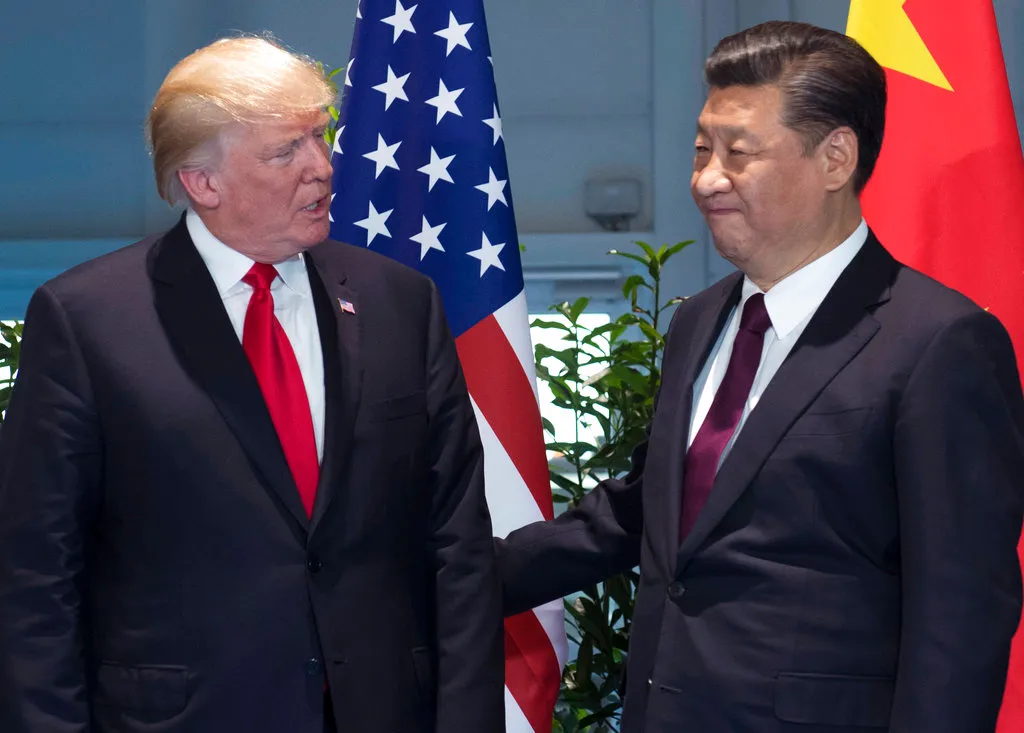FILE - In this July 8, 2017, file photo, U.S. President Donald Trump, left, and China's President Xi Jinping arrive for a meeting on the sidelines of the G-20 Summit in Hamburg, Germany. President Trump has often named Asia, and China and Japan in particular, as a source of American economic woes. A persisting U.S. trade deficit with most Asian countries and the president’s frequent threats to impose sanctions or raise tariffs on exports from the region make trade a fraught issue. (Saul Loeb/Pool Photo via AP, File)