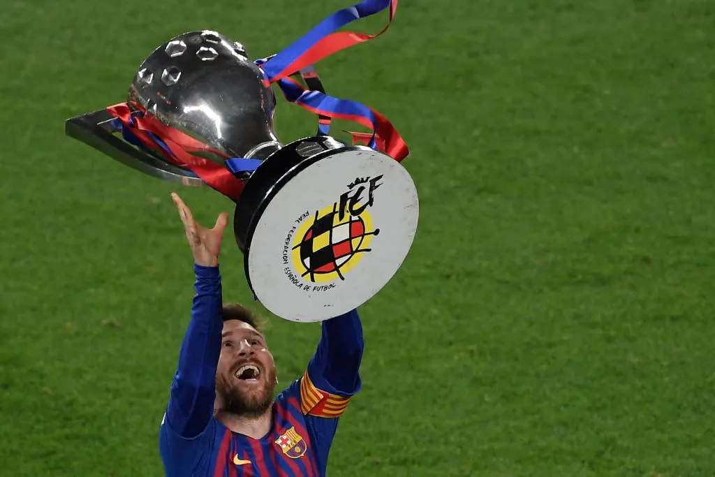 Lionel Messi raises one of his 10 La Liga trophies