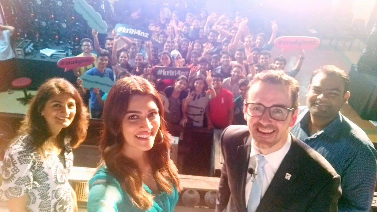 Kriti Sanon taking a selfie with students
