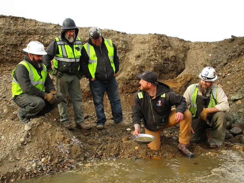 Rick Ness looking at crew members while panning for gold.