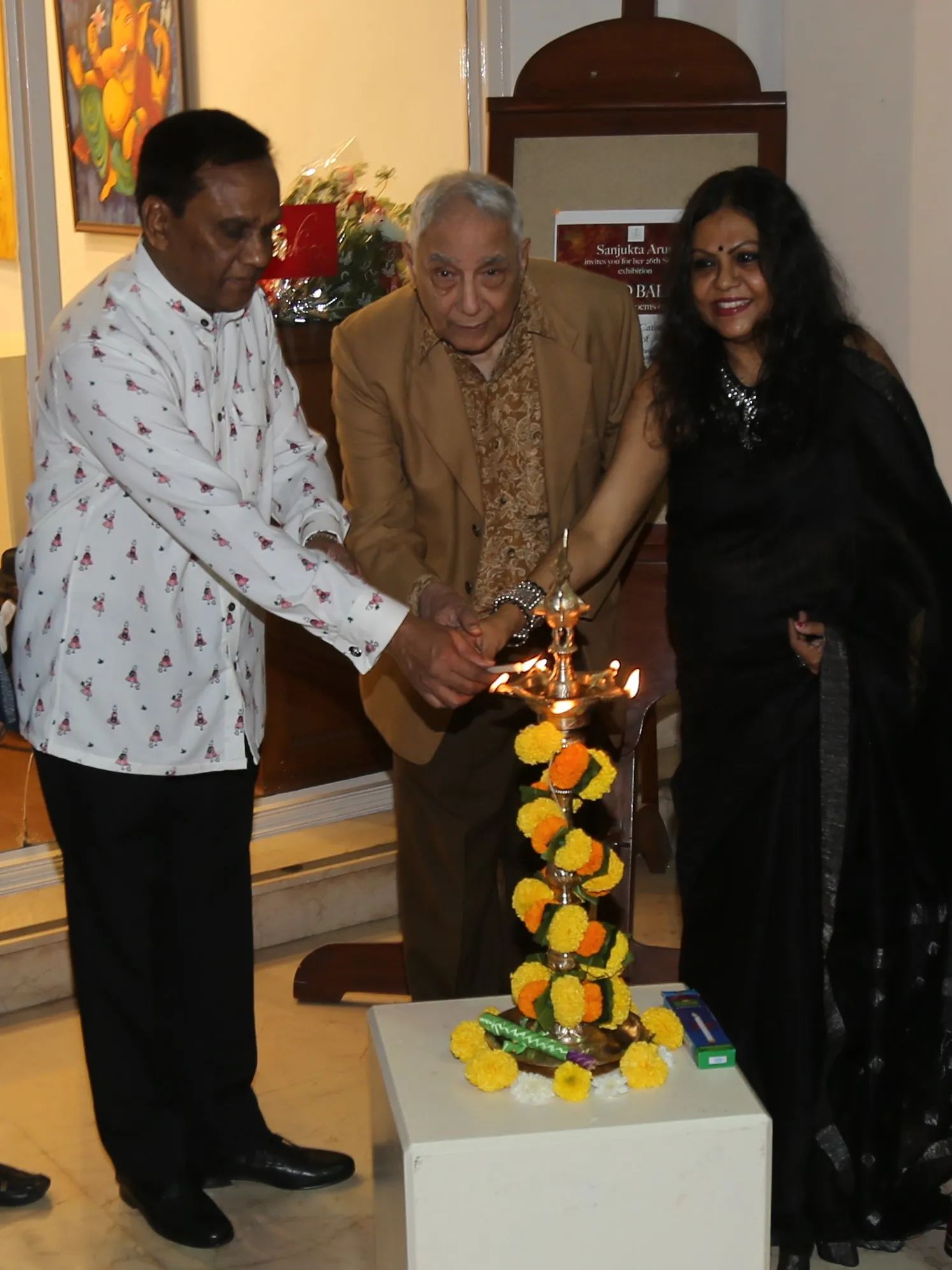 Ambassador Valsan Vethody, Yogendra Sapru, Founder-Chairman CPAA & Artist Sanjukta Arun lighting the lamp at Sanjukta Arun's Painted Ballads exhibition