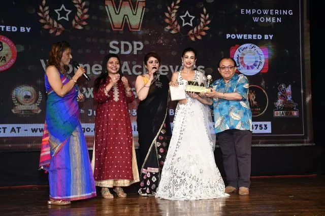 Shomu Mitra with Dr. Daljeet Kaur and Nandita Puri awarding Monami Ghosh