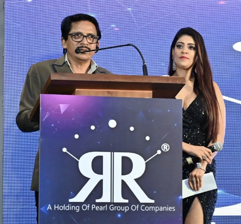 RR-event Ronnie Rodrigues speaks on stage as compere Pritee Kathpal watches