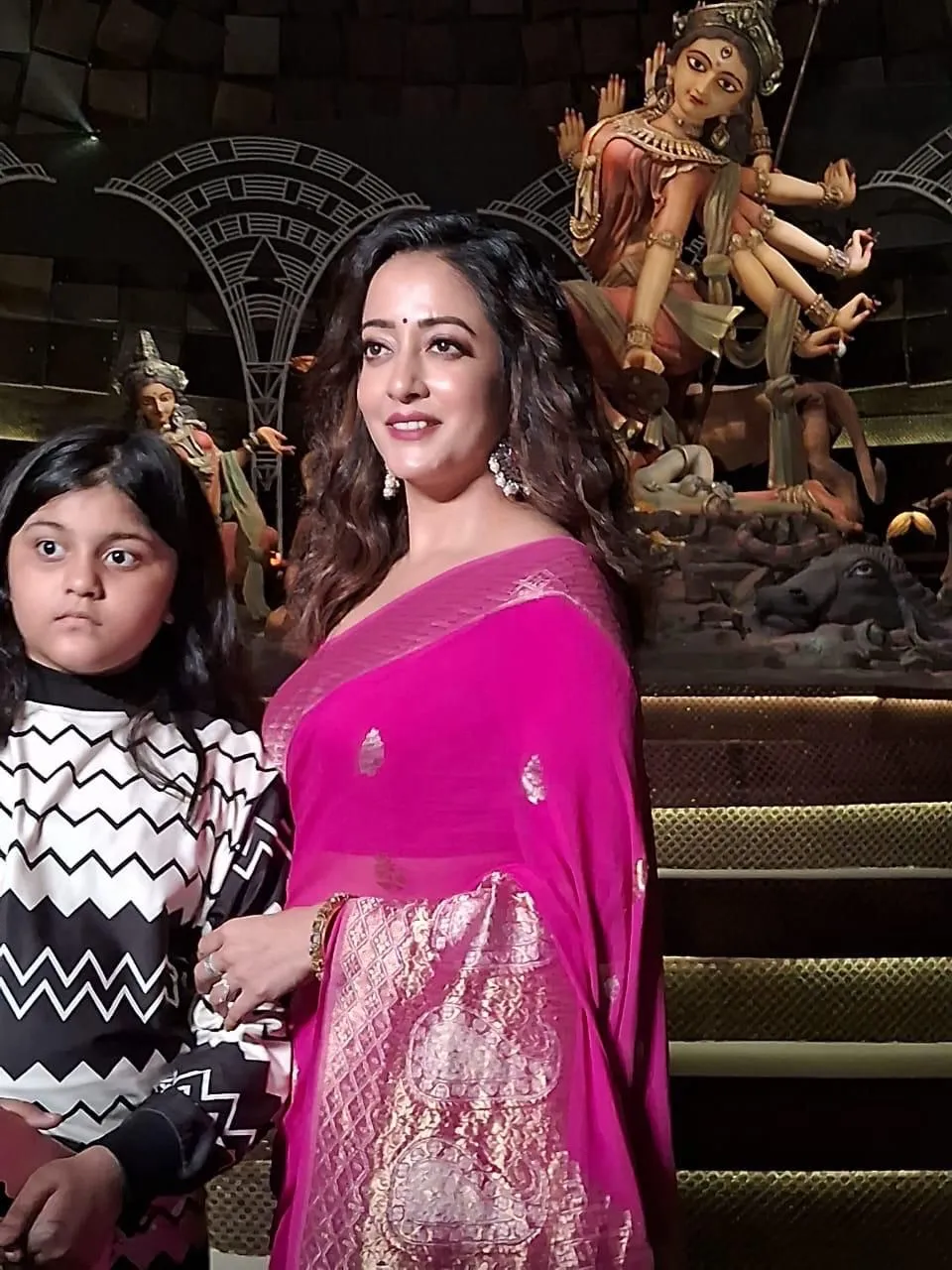 Raima Stuns in Pink Banarasi Sari at Durga Puja Festivities