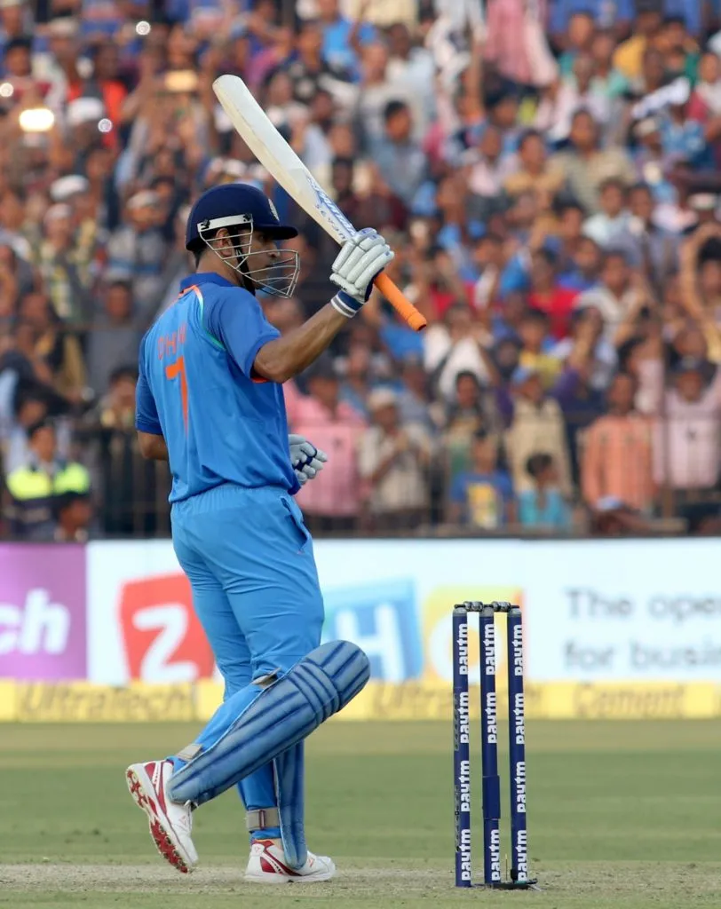 Cuttack: MS Dhoni of India raises his bat to celebrate his century during the Second One Day International cricket match between India and England at Barabati Stadium in Cuttack on Jan 19, 2017. (Photo: Surjeet Yadav/IANS)