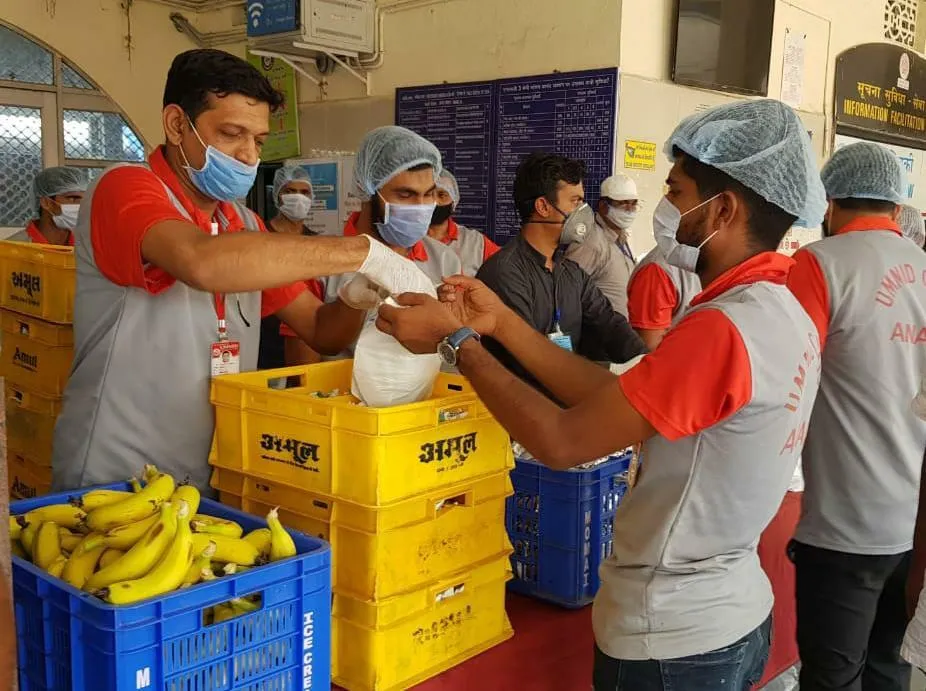  distribution of packaged drinking water bottles to passengers of a  Shramik special train at Rajkot station.