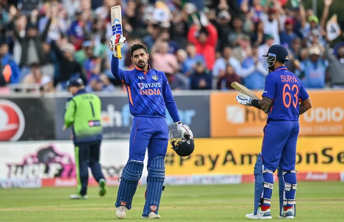 Deepak Hooda raises his bat after reaching his maiden T20I century, Ireland vs India, 2nd T20I, Dublin, June 28, 2022 