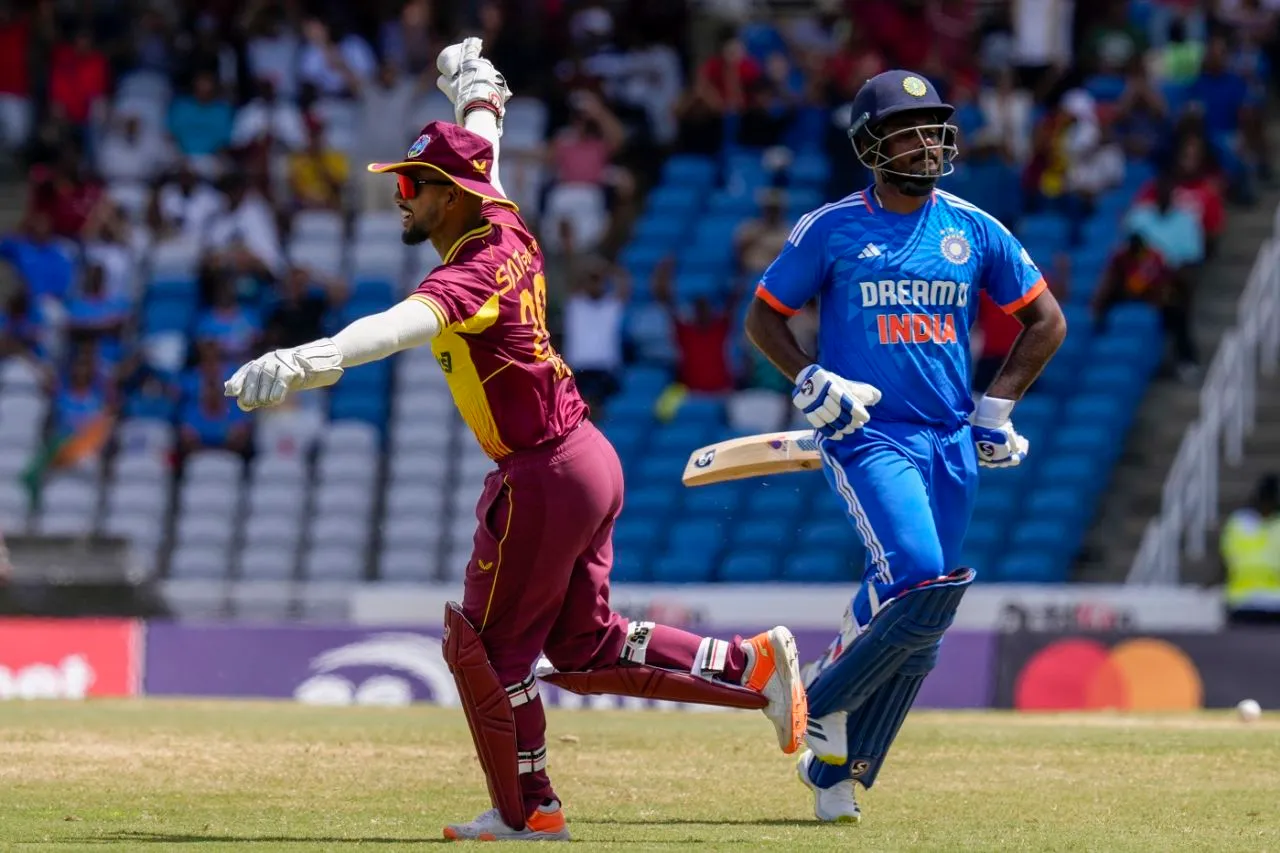 Nicholas Pooran celebrates after Sanju Samson was run out