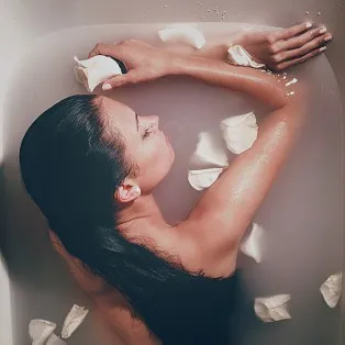 woman taking a milk bath by Hector Vazquez. Photo stock - StudioNow
