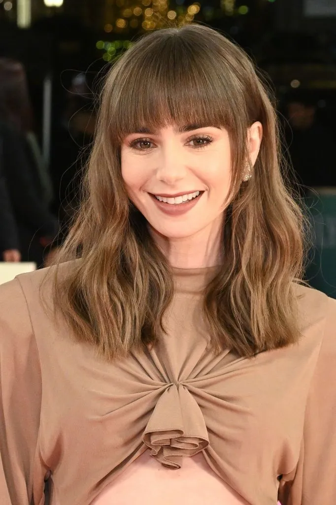lily collins with shoulder length hair and fringe