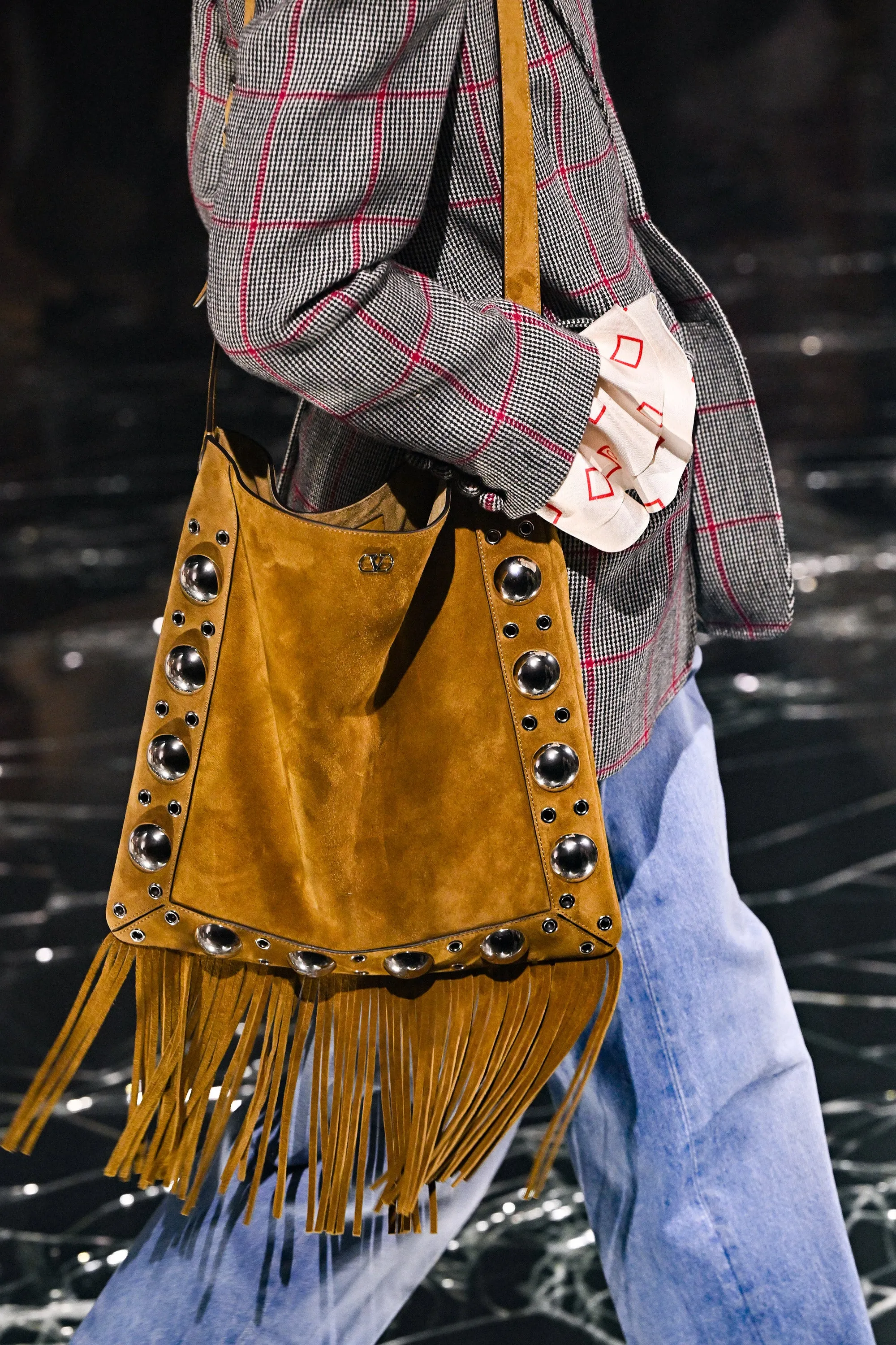 A model, bag detail, walks the runway during the Valentino Paris Womenswear Spring-Summer 2025 show as part of Paris Fashion Week on September 29, 2024 in Paris, France