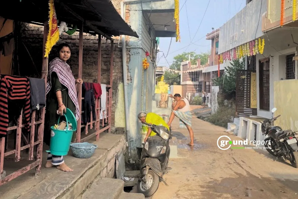A woman waits for a garbage pickup vehicle in the Kasba area of ​​Sehore