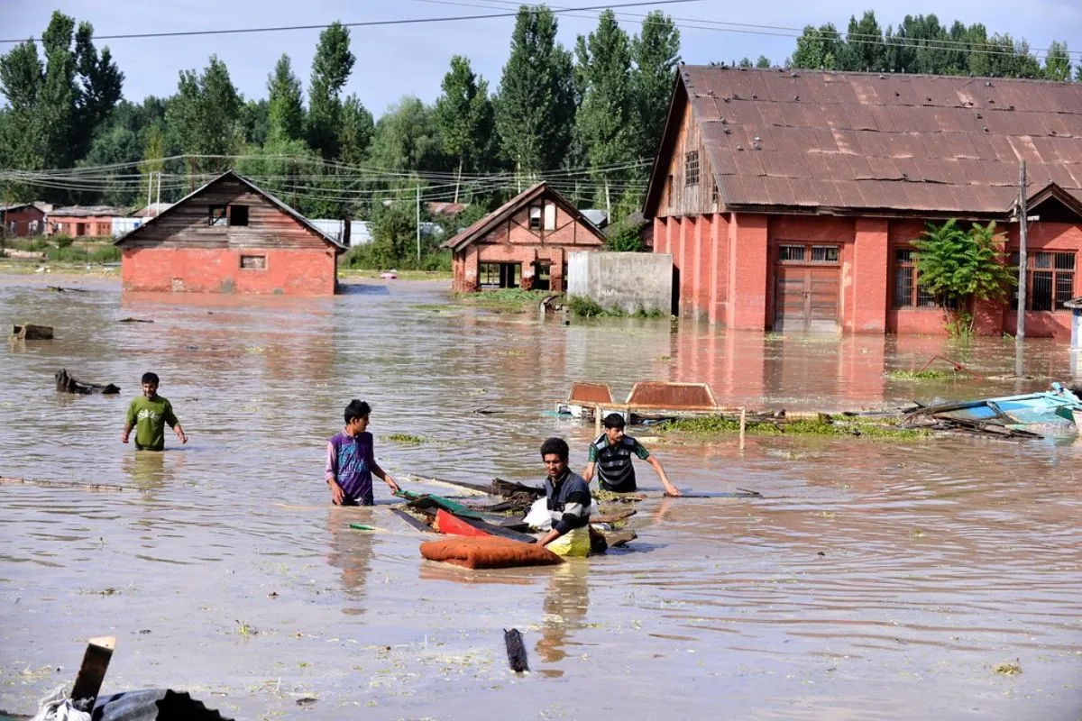 Kashmiri people try to save their household belongings after their homes were flooded near river Jhelum in Srinagar, Jammu and Kashmir