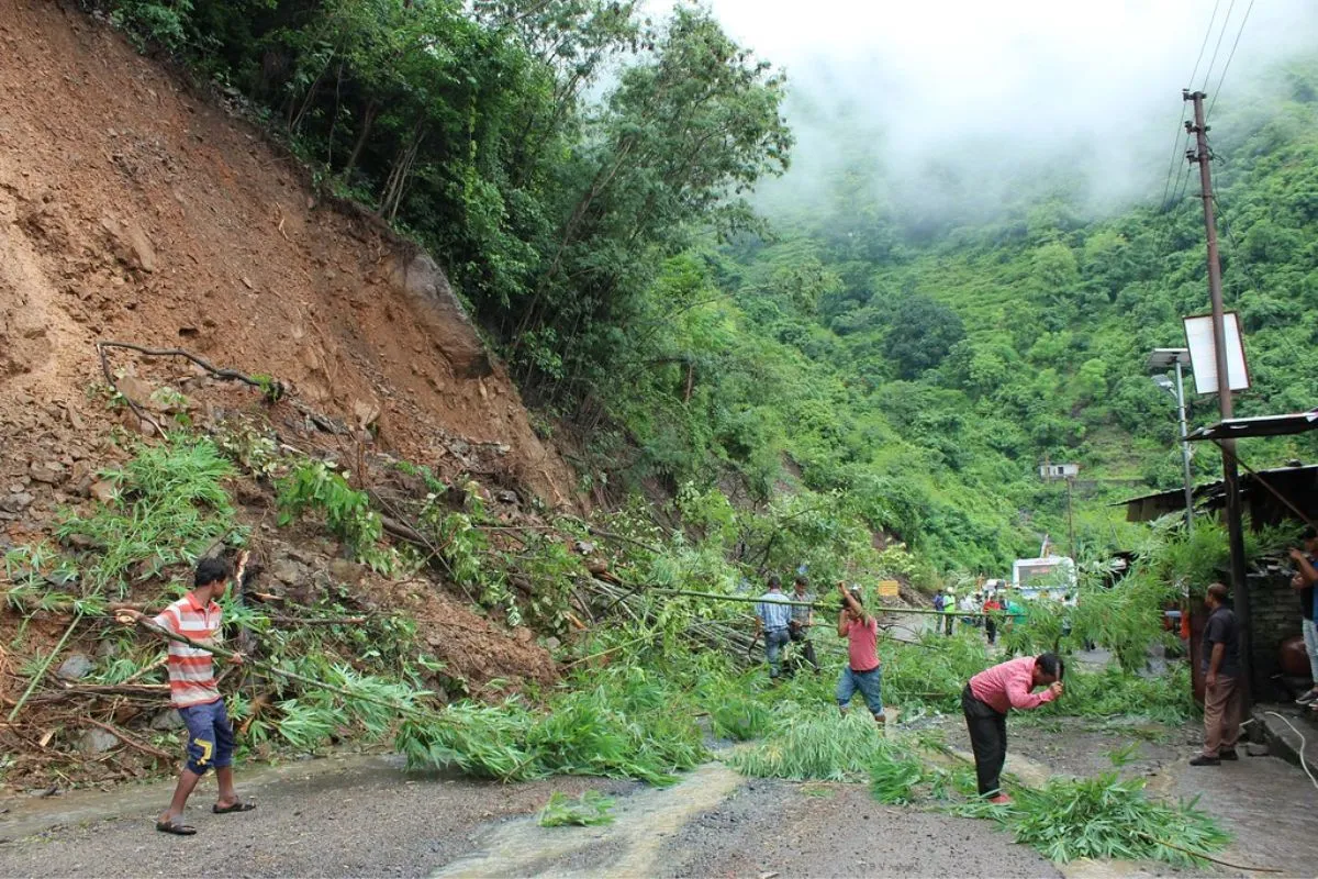 Residents of Uttarakhand clear debris following a landslide, highlighting the region's increasing vulnerability to such natural disasters