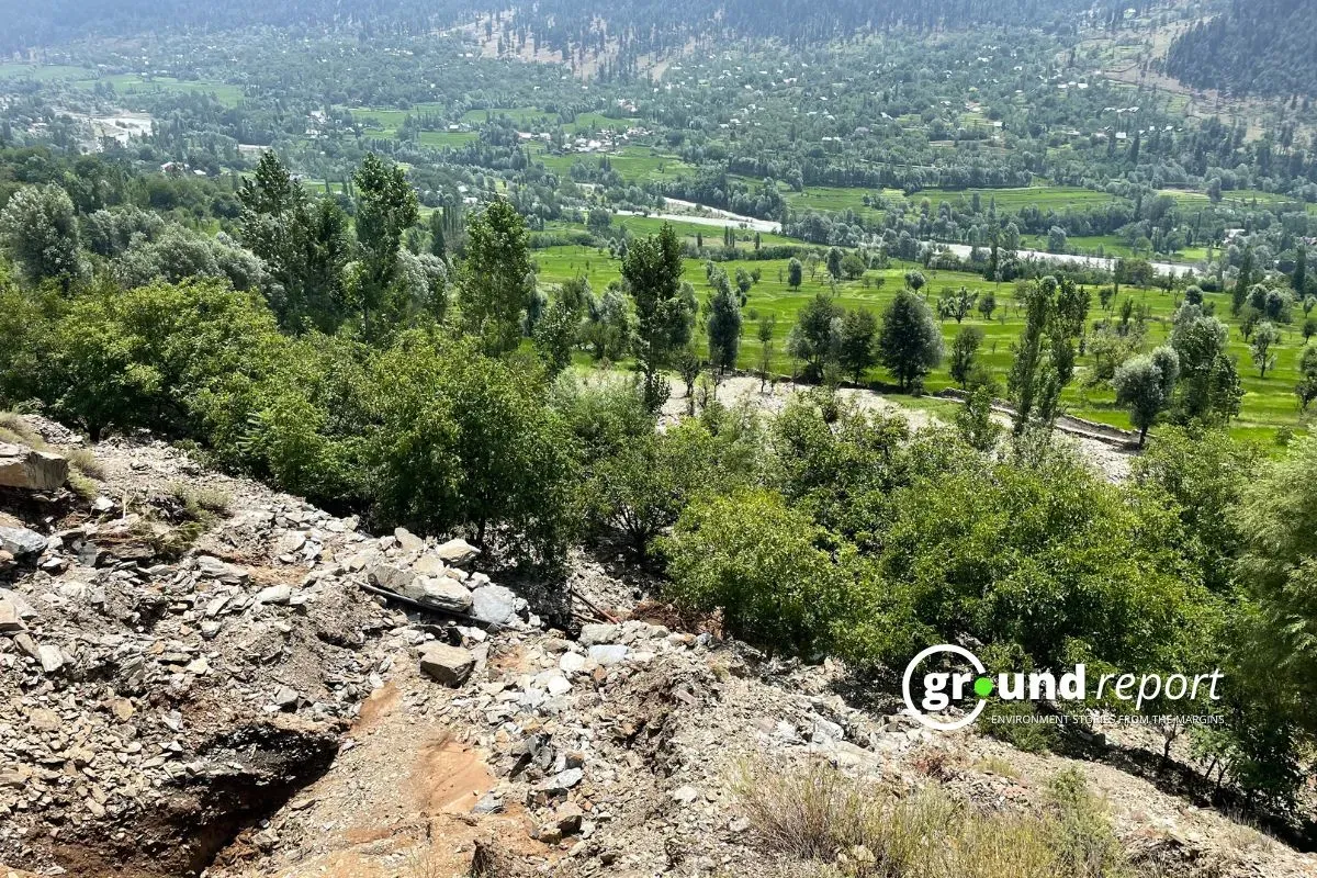 A view of the green fields below, with the hillside in Kawacherwan village covered in debris from the recent cloudburst