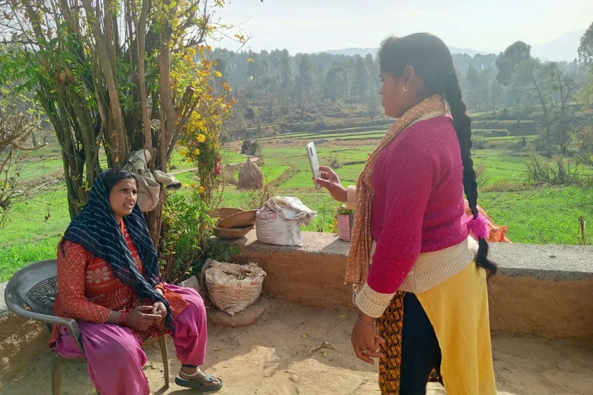 A health worker from the Tiya Foundation conducts a telemedicine consultation with a villager, leveraging mobile technology to provide medical advice in rural Uttarakhand