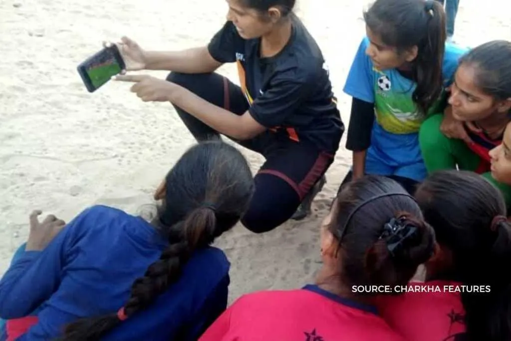 Girls learning soccer skills through smartphones 