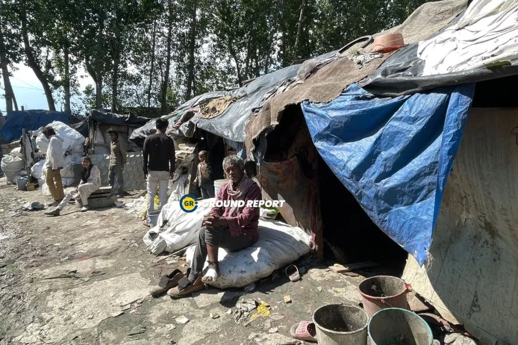 A tired elderly rag picker takes a break, finding solace outside their humble shack. Photo Credit: Seerat Bashir/Ground Report