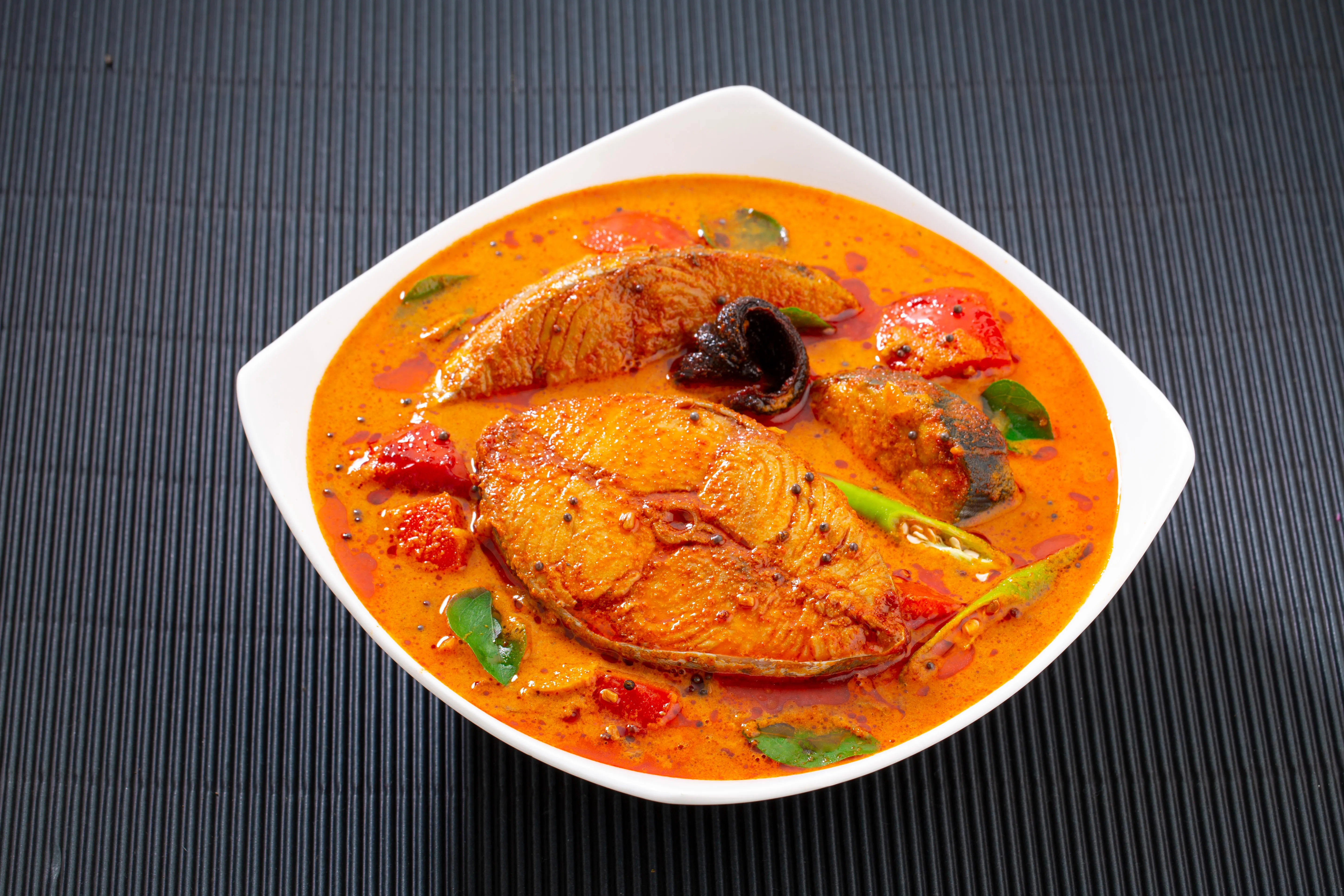 fish-curry special dish white bowl garnished-with curry leaves