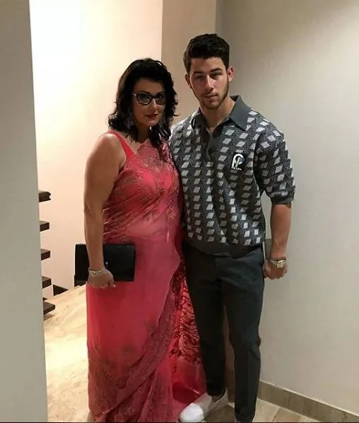 Nick Jonas strikes a pose with mother at engagement bash.