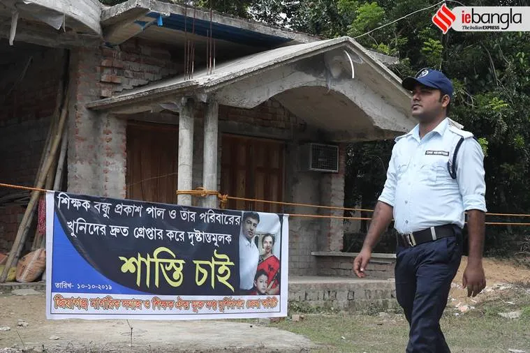 Civic volunteer outside Closed house of Bandhu Prakash Paul. The bodies 35 year old Bandhu Prakash Pal along with his wife Beauty and son Arya were found dead at this in Jiaganj, Murshidabad on Tuesday.Express photo by Partha Paul.Jiaganj.11.10.2019.
