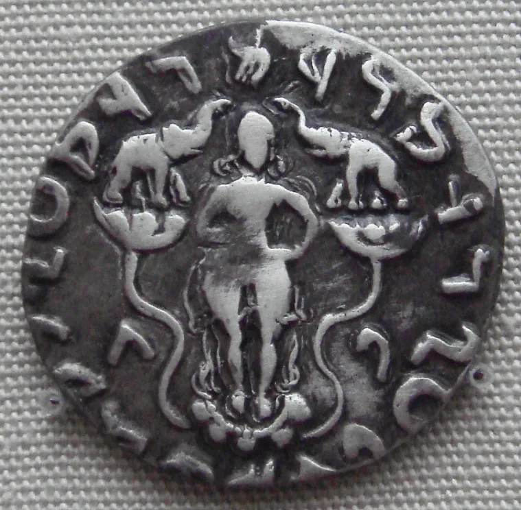 A coin from Indo-Scythian king Azilises's reign, showing Gaja Lakshmi standing on a lotus. From the coins of Gandhara, 1st century BCE. 