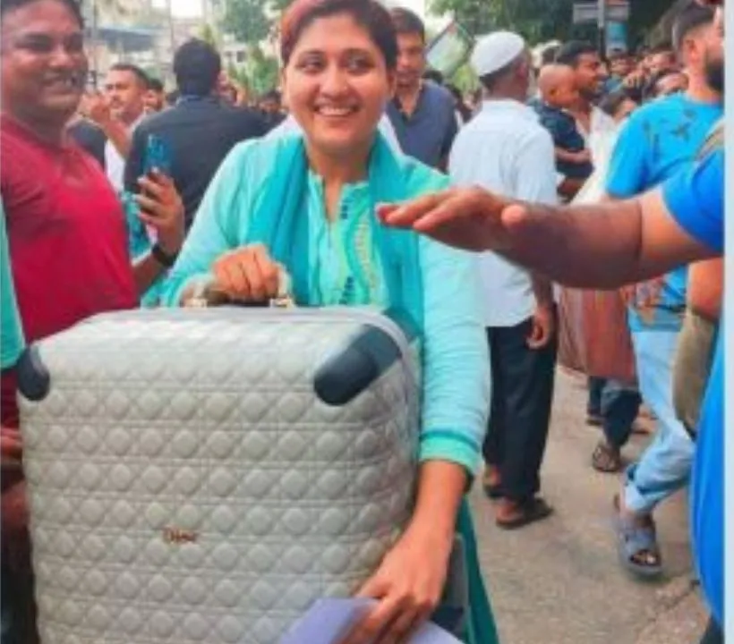 The viral photo shows a woman holding the Dior bag and smiling (Image source: @pooja_news/X)