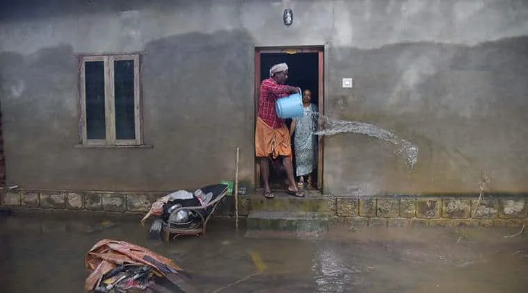 Man pours water out of flooded home