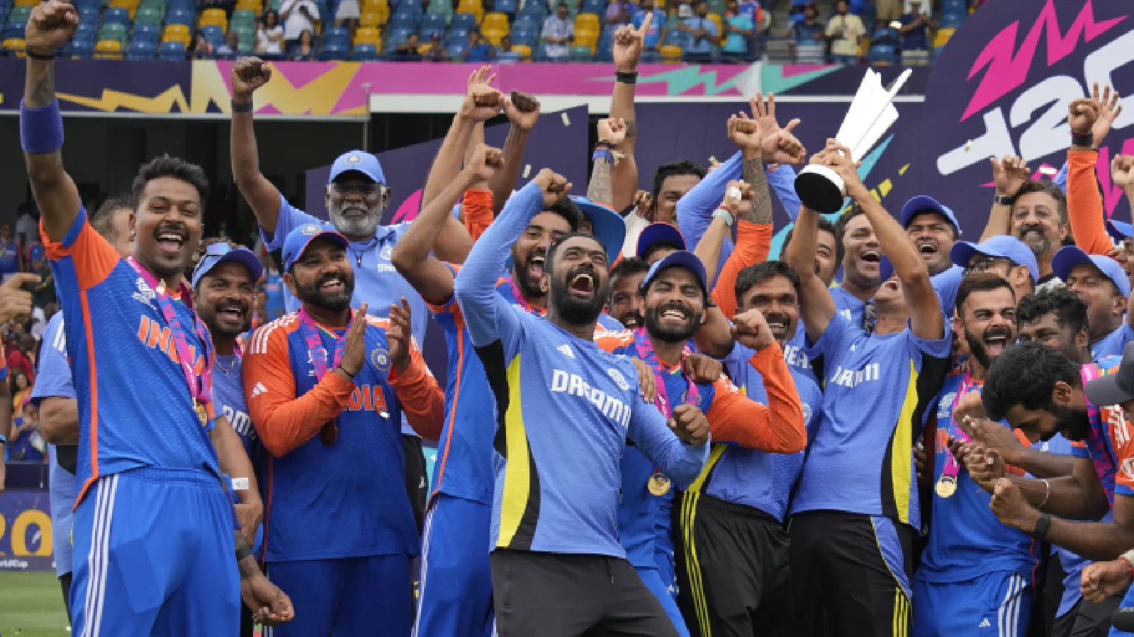 Indian cricket team players and team support staff celebrate with the winners trophy after defeating South Africa in the ICC Men's T20 World Cup final cricket match at Kensington Oval in Bridgetown. (AP Photo)