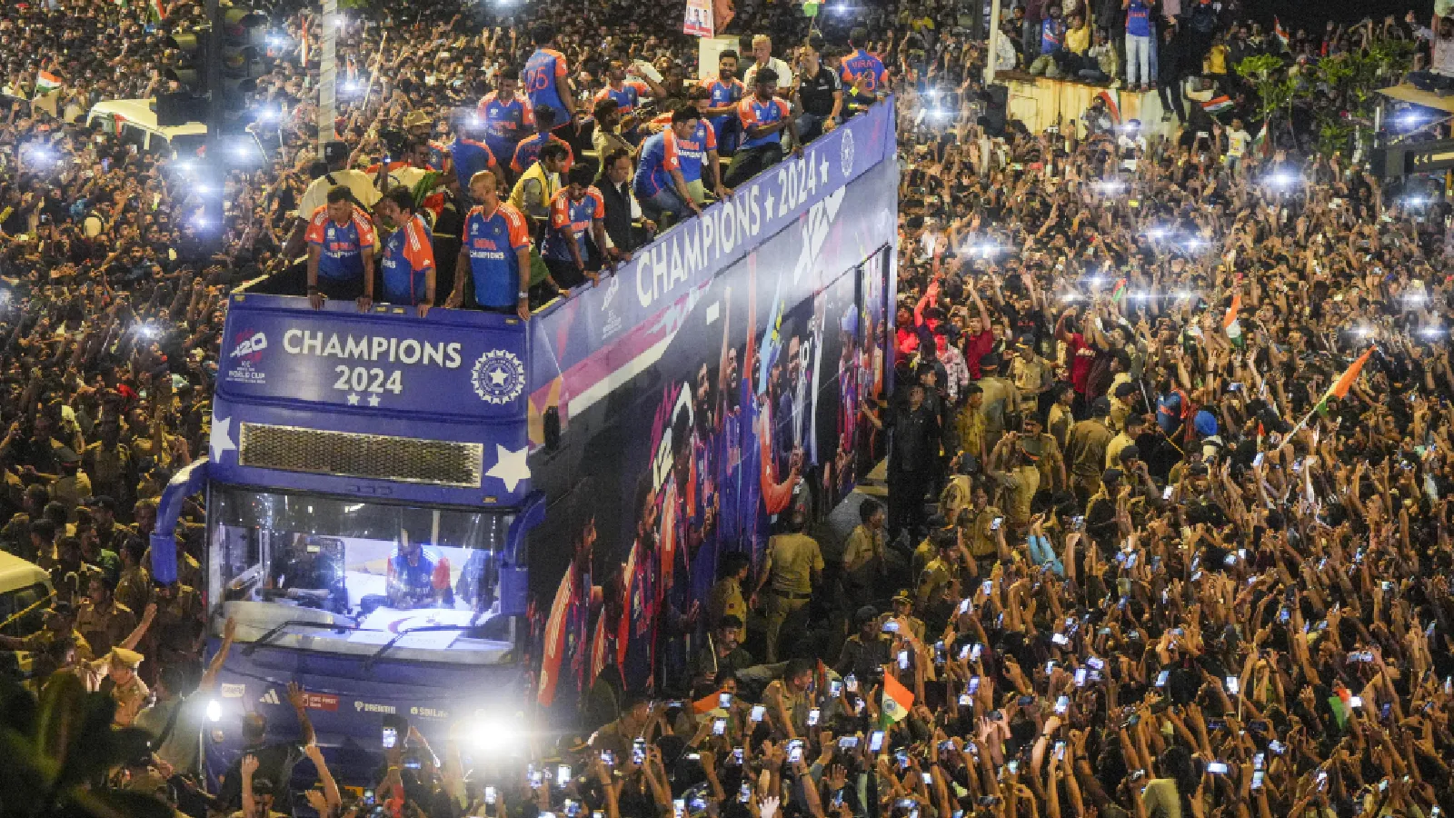 Players of the T20 World Cup-winning Indian cricket team acknowledge fans during their open bus victory parade, in Mumbai. (PTI)