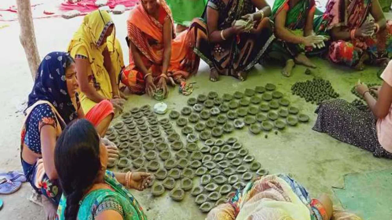 women making diwali diyas