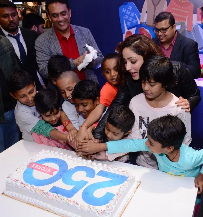 Yami cuts cake with NGO kids