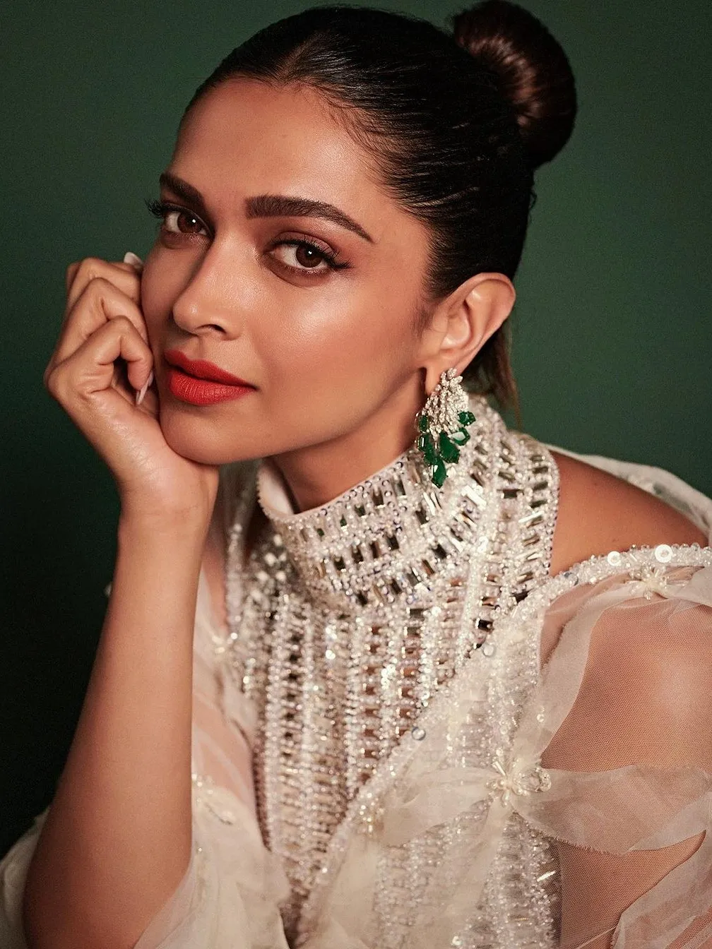 Deepika Padukone is the perfect wedding guest muse in a red pout and gelled  hair bun | Vogue India