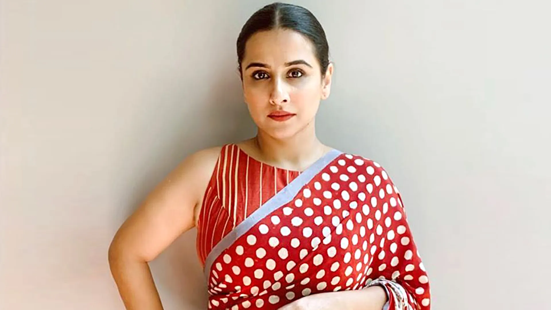 Vidya Balan paired her red and white polka dot sari with an interesting  sleeveless striped blouse | VOGUE India