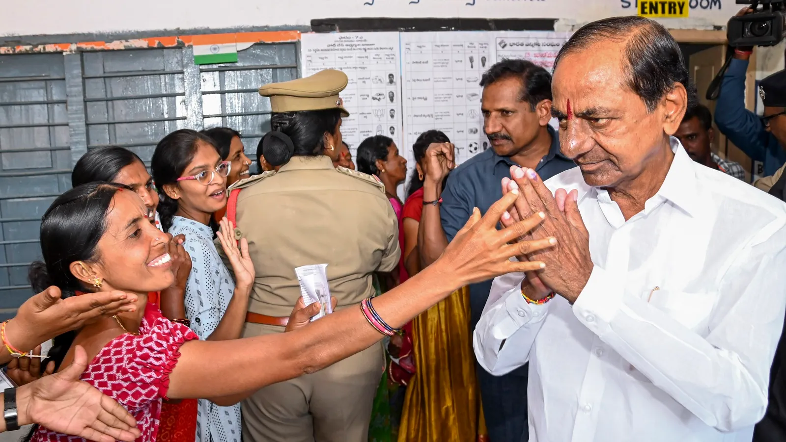 Telangana Chief Minister and BRS president K. Chandrashekhar Rao greets supporters after casting his vote for the State Assembly elections, at Chintamadaka in Siddipet district