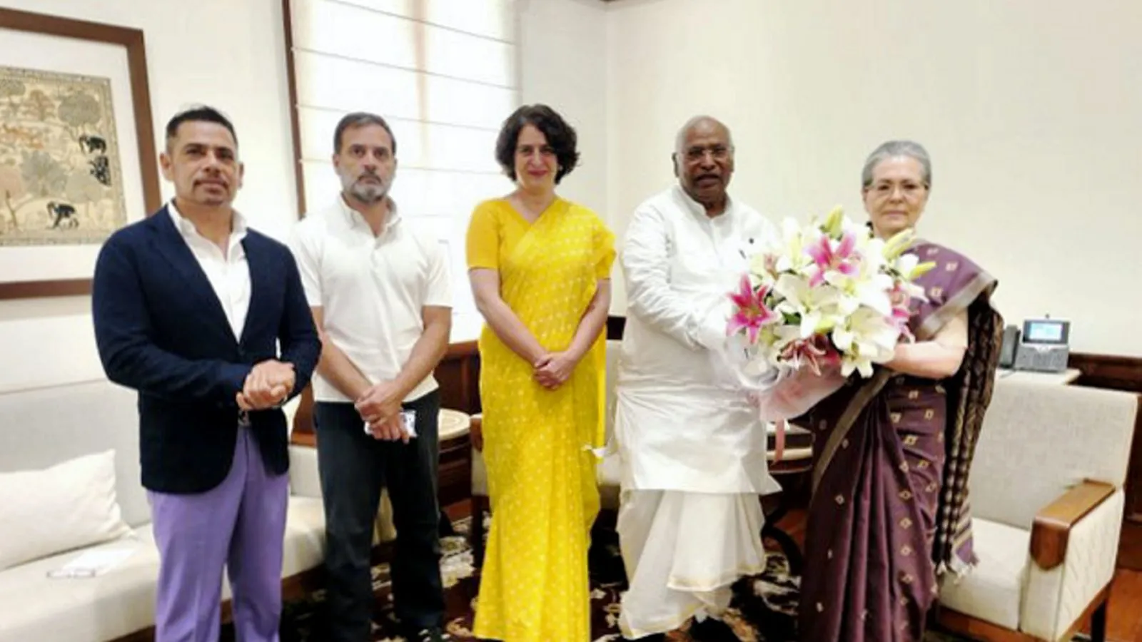Congress President Mallikarjun Kharge greets party leader Sonia Gandhi before she takes oath as a member of the Rajya Sabha from Rajasthan, in New Delhi, Thursday, April 4, 2024
