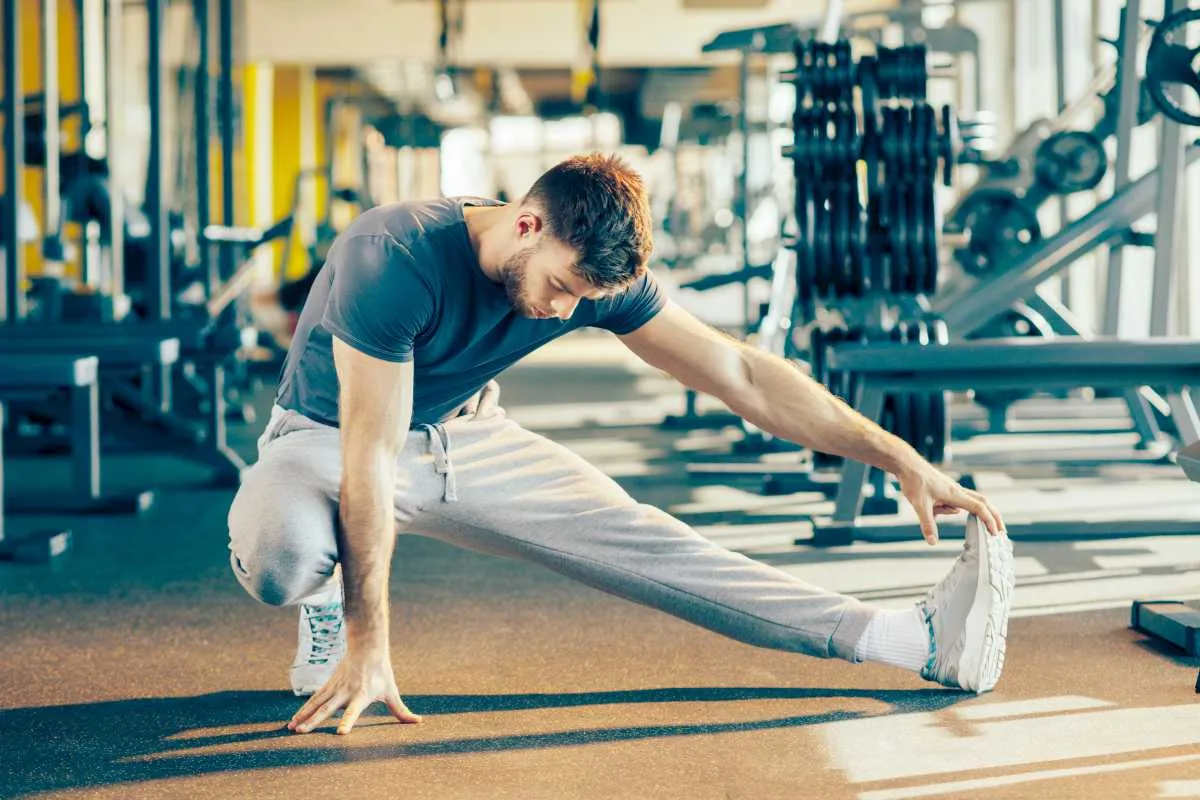 handsome man doing warm gym stretching aerobics ss 