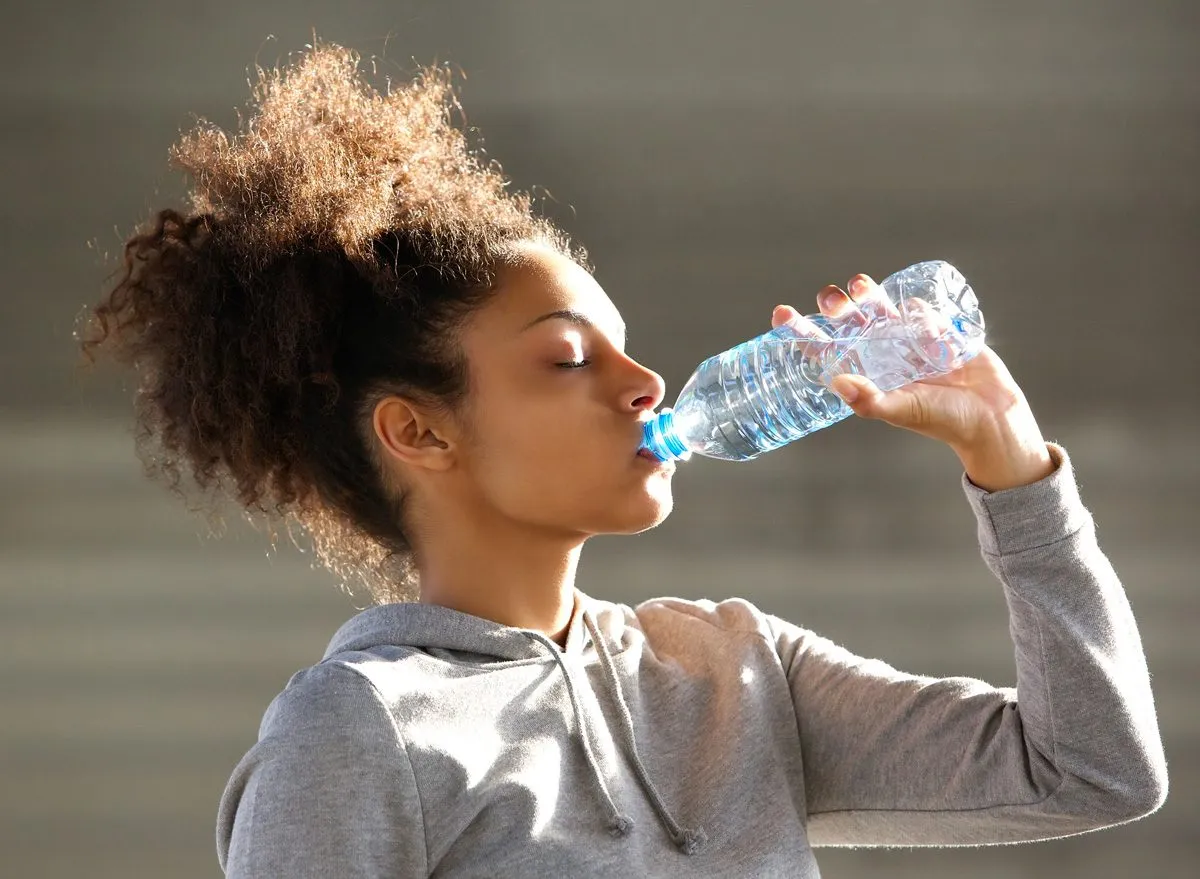  woman drinking bottled water 