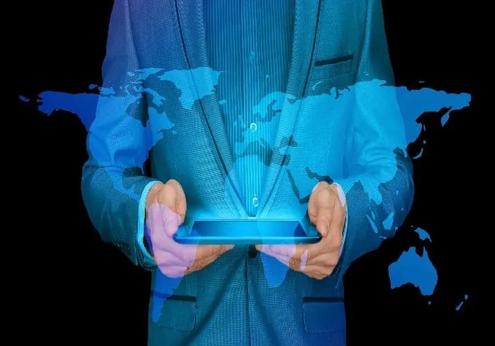 man with an ipad which has a world projection