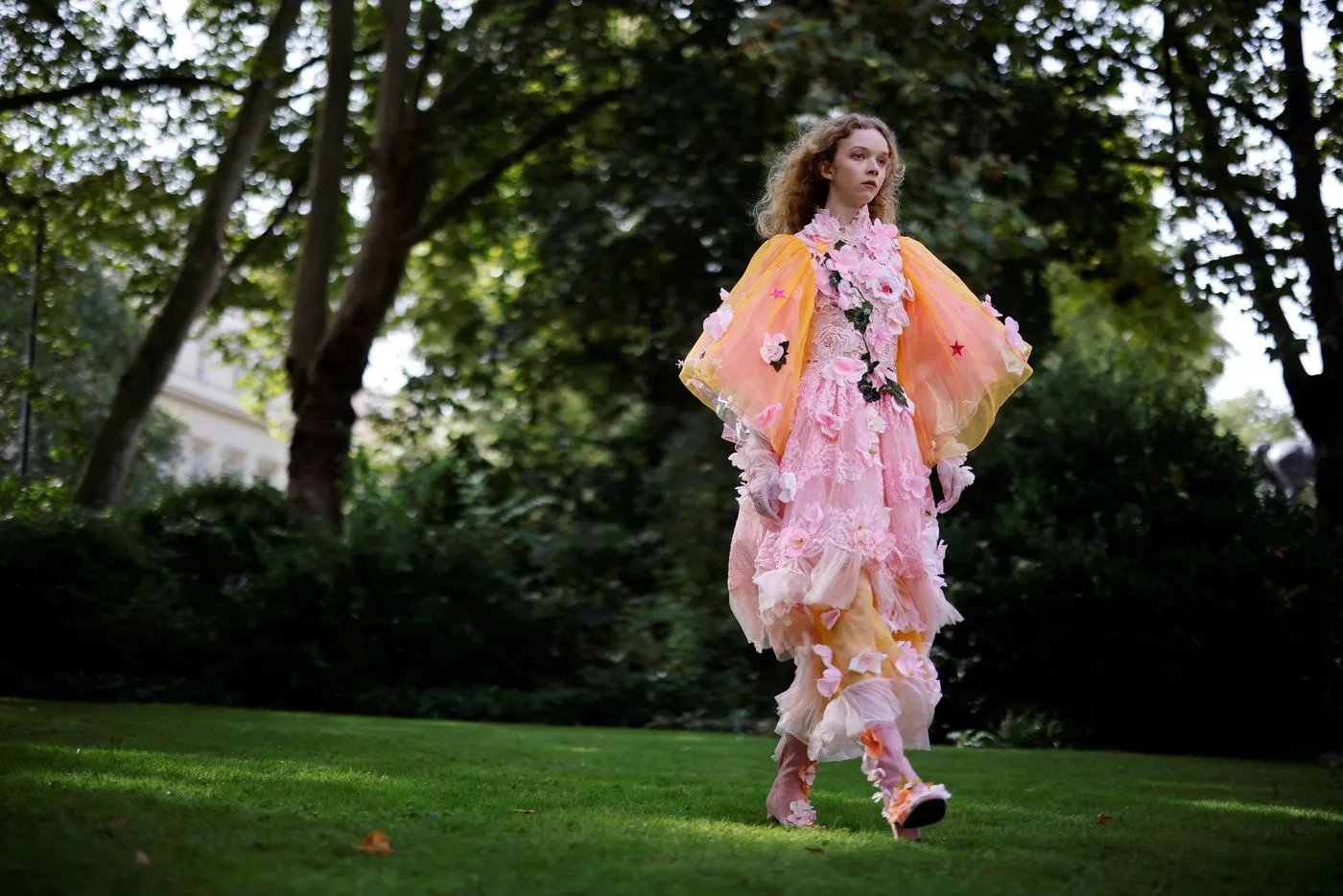 A model presents creations from London-based Turkish designer Bora Aksu during a catwalk show for the Spring/Summer 2022 collection on the first day of London Fashion Week in London on Sept. 17, 2021. -