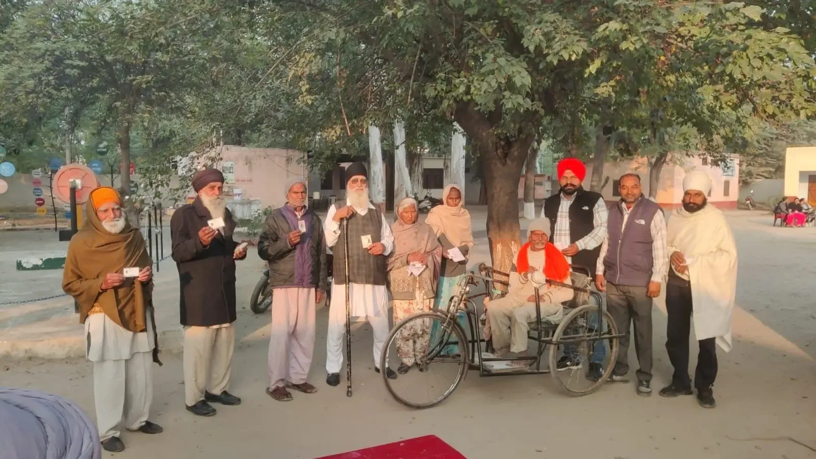 Voters displaying their voter ID cards at Village Patti in the Chabbewal assembly segment of Punjab before casting their votes on Wednesday morning.