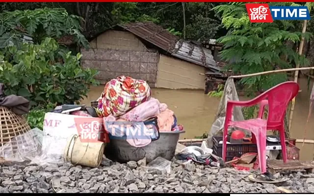People gather essential items along railway tracks   
