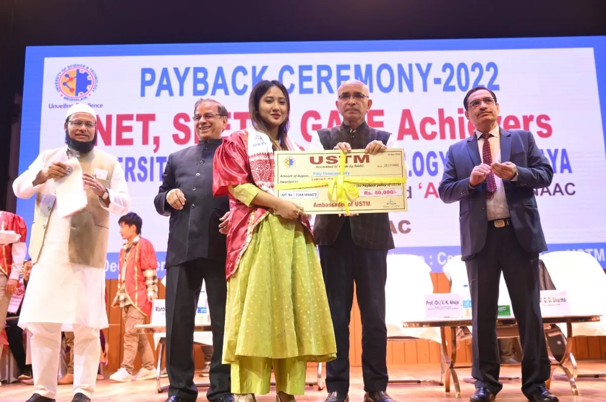 A student receiving fees back from USTM as a reward for cracking competitive exams   