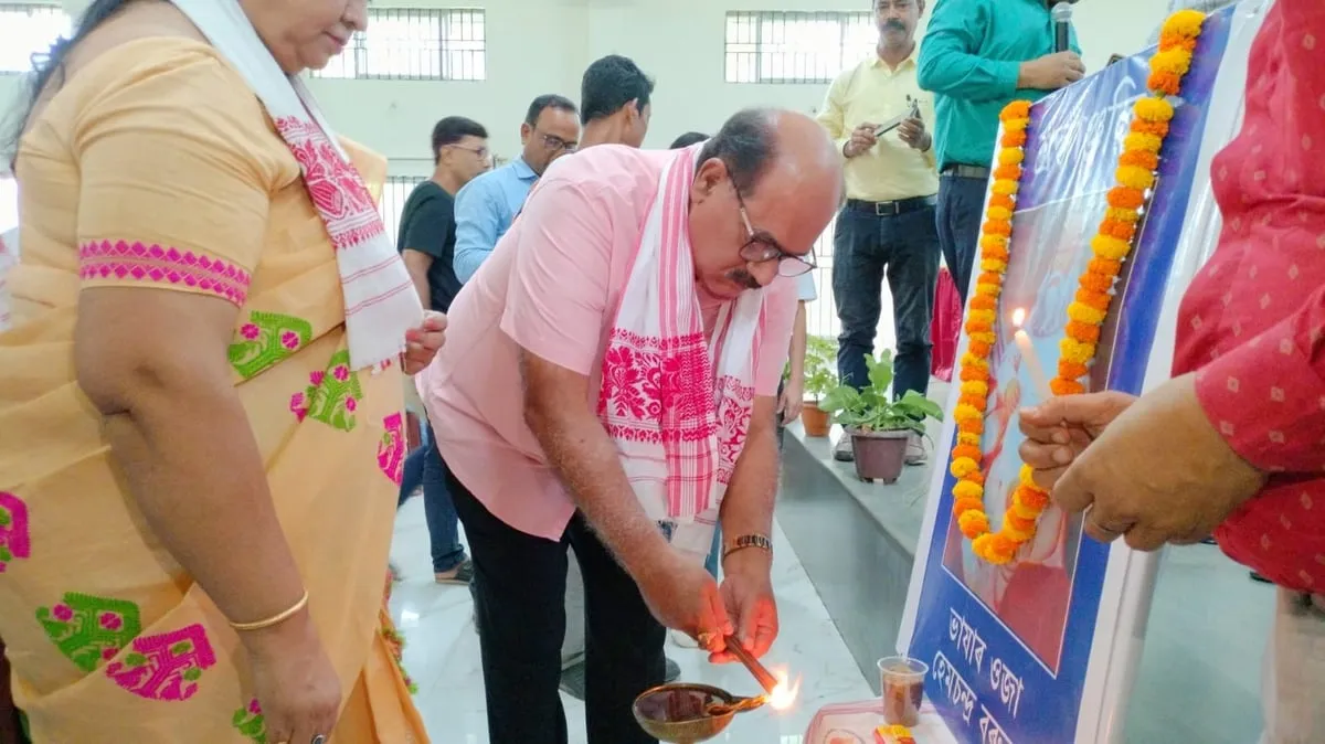 Jayanta Baruah lights ceremonial lamp in front of Hemchandra Baruah's portrait  