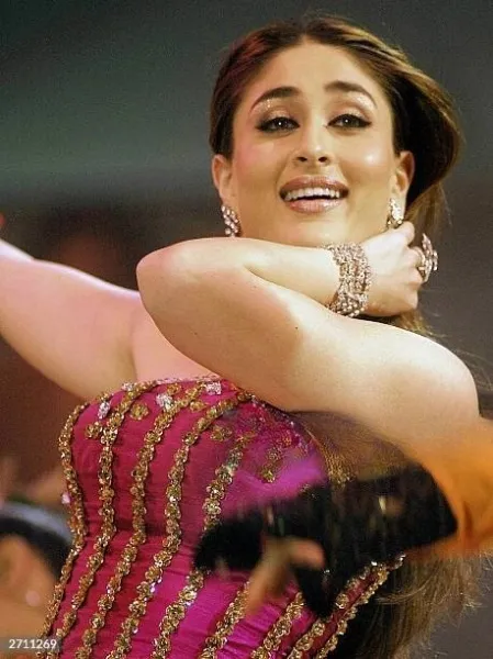 Kareena kapoor debutted in Bollywood. She is wearing a beautiful pink dress with marble ear rings and wrist band.  