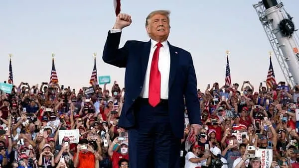 US President Donald Trump arrives for a campaign rally at Orlando Sanford International Airport. (AP)