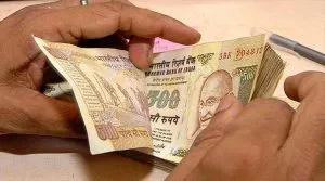 Rupee pushes up 14 paise on dollar's global weakness